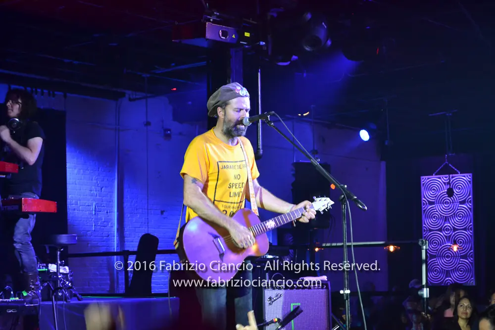 Musician performing on a blue-lit stage