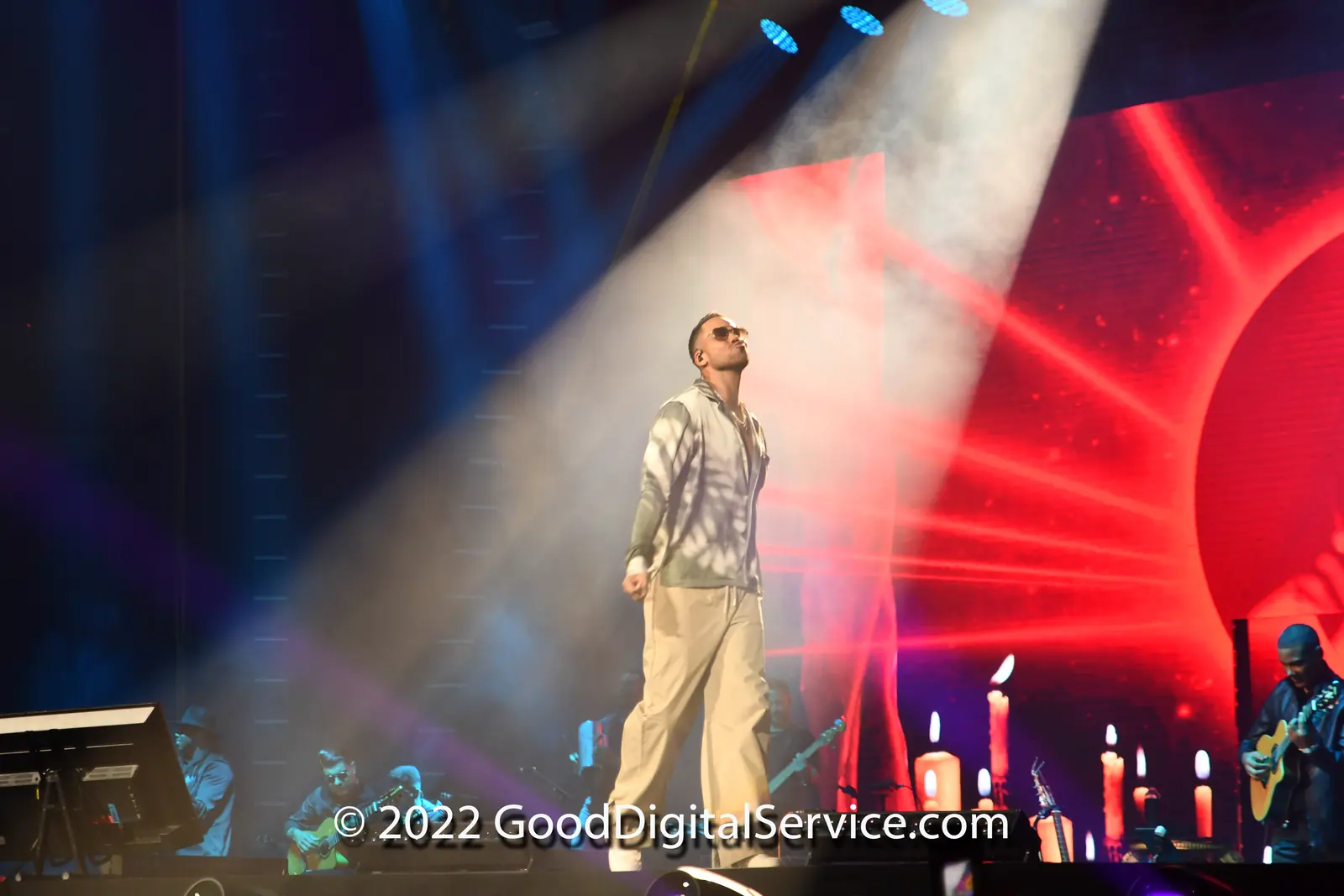 Performer on stage in red and blue light