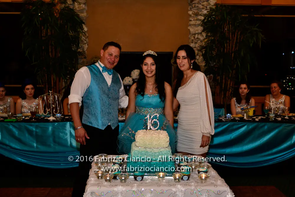 Family celebrating beside a birthday cake